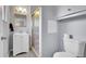 Bathroom featuring a vanity, mirror, lighting, and walk-in shower with glass doors at 12020 W Alabama Pl, Lakewood, CO 80228