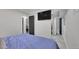 Bedroom with a tv and open closet area leads to an ensuite bath at 12020 W Alabama Pl, Lakewood, CO 80228
