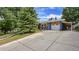 Charming home with a concrete driveway, attached garage and carport, and a beautifully landscaped front yard at 12020 W Alabama Pl, Lakewood, CO 80228