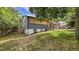 Charming home with a brick and wood exterior, complemented by mature trees and a well-maintained lawn at 12020 W Alabama Pl, Lakewood, CO 80228