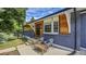 Inviting front porch with chairs, wood accents, updated brick, and appealing curb appeal for relaxed outdoor living at 12020 W Alabama Pl, Lakewood, CO 80228
