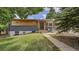 Charming home with a modern exterior, painted brick and light wood, inviting front yard, and a cozy sitting area at 12020 W Alabama Pl, Lakewood, CO 80228