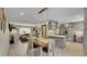 Open concept kitchen features stainless appliances, a kitchen island and dining area, and abundant natural light at 12020 W Alabama Pl, Lakewood, CO 80228