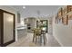 Open-concept kitchen with stainless appliances, granite countertops, island seating, and seamless flow to dining area at 12020 W Alabama Pl, Lakewood, CO 80228