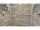 Shower stall with dual shower heads and wood-look tile on the walls at 12020 W Alabama Pl, Lakewood, CO 80228