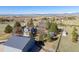 Stunning aerial view of home with outbuildings on fenced acreage, mountain views and lush landscaping at 2610 W County Road 4, Berthoud, CO 80513