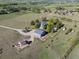 Aerial view showcases the property with house, garage, and surrounding fields at 2610 W County Road 4, Berthoud, CO 80513
