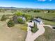 Aerial view features house, garage, and large yard with circular driveway and mature trees at 2610 W County Road 4, Berthoud, CO 80513