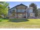 Home featuring a two-story patio, spiral staircase, hot tub, and large yard at 2610 W County Road 4, Berthoud, CO 80513