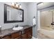 Simple bathroom featuring a brown vanity, large mirror and separate bath with shower at 2610 W County Road 4, Berthoud, CO 80513