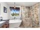 Beautiful bathroom featuring modern tub, glass-enclosed shower and views of the surrounding landscape at 2610 W County Road 4, Berthoud, CO 80513