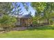 Custom outbuilding with fenced yard and lush greenery at 2610 W County Road 4, Berthoud, CO 80513