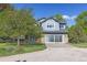 Two-story home with a large, multi-paned glass garage door and nicely manicured landscaping at 2610 W County Road 4, Berthoud, CO 80513