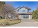 Inviting two-story home with a brick facade and a concrete driveway surrounded by mature landscaping at 2610 W County Road 4, Berthoud, CO 80513