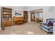Spacious living room with carpet floors, a piano, and open access to the dining area at 2610 W County Road 4, Berthoud, CO 80513