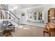 Bright and airy living room with large windows, a cozy window seat, and a staircase at 2610 W County Road 4, Berthoud, CO 80513