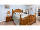 Close up of main bedroom featuring a rustic wood bed frame and matching bedside table at 2610 W County Road 4, Berthoud, CO 80513