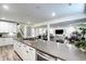 Finished basement bar area with island seating, overlooking a large entertaining area at 6521 Barnstead Dr, Castle Pines, CO 80108