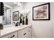 Modern bathroom featuring white cabinets, quartz countertop, and black hardware at 6521 Barnstead Dr, Castle Pines, CO 80108