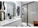 Modern bathroom featuring a glass-enclosed shower, stylish vanity, and sleek black hardware at 6521 Barnstead Dr, Castle Pines, CO 80108