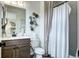 Charming bathroom with vanity, toilet, and shower with curtain at 6521 Barnstead Dr, Castle Pines, CO 80108