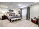 Finished basement bedroom with a decorative accent wall and neutral carpeting at 6521 Barnstead Dr, Castle Pines, CO 80108