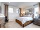 Bright bedroom featuring a wood frame bed, neutral walls, and carpet at 6521 Barnstead Dr, Castle Pines, CO 80108