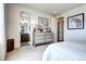 Bright bedroom showcasing a large dresser and ensuite bathroom at 6521 Barnstead Dr, Castle Pines, CO 80108