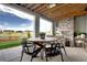 Covered patio with an outdoor fireplace and stunning views of the backyard at 6521 Barnstead Dr, Castle Pines, CO 80108