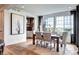 Bright dining room features hardwood floors, large windows, and a stylish modern table set at 6521 Barnstead Dr, Castle Pines, CO 80108