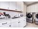 Functional laundry room equipped with modern washer and dryer at 6521 Barnstead Dr, Castle Pines, CO 80108