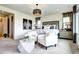 Serene main bedroom featuring a king bed, sitting area, and stylish lighting fixtures at 6521 Barnstead Dr, Castle Pines, CO 80108