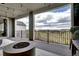 Covered patio area showcasing black railing and peaceful views at 6521 Barnstead Dr, Castle Pines, CO 80108