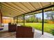 Covered back porch with outdoor seating and a view of the fenced-in lawn at 2448 S Leyden St, Denver, CO 80222