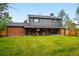 Large backyard view with a covered patio, offering a relaxing outdoor space and green lawn at 2448 S Leyden St, Denver, CO 80222
