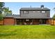 Expansive backyard featuring a well-maintained lawn and a covered patio with comfortable seating, great for outdoor living at 2448 S Leyden St, Denver, CO 80222