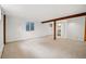 Finished basement with rustic wooden support beams and recessed lighting at 2448 S Leyden St, Denver, CO 80222