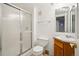 Bright bathroom with a glass-enclosed shower and a classic vanity with a sink at 2448 S Leyden St, Denver, CO 80222