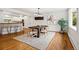 The dining room offers natural light, a modern light fixture, and wood floors at 2448 S Leyden St, Denver, CO 80222