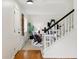 Welcoming entryway with hardwood floors leading to a carpeted living area and a staircase at 2448 S Leyden St, Denver, CO 80222