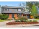 Attractive two-story home with a brick facade, gray siding, well-maintained landscaping, and a two-car garage at 2448 S Leyden St, Denver, CO 80222