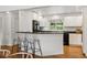 Eat-in kitchen with modern appliances and breakfast bar at 2448 S Leyden St, Denver, CO 80222
