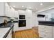 Kitchen with modern appliances and white cabinets at 2448 S Leyden St, Denver, CO 80222
