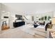 Bright living room with a staircase, hardwood floors, and a large window for natural light at 2448 S Leyden St, Denver, CO 80222