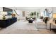 Bright living room features a modern couch, stylish decor and large windows bringing the outside in at 2448 S Leyden St, Denver, CO 80222