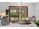 Charming sitting area with stylish chairs, a decorative rug, and sliding glass doors opening to the backyard at 2448 S Leyden St, Denver, CO 80222