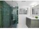 Stylish bathroom with green tiled shower, sleek vanity, and modern fixtures at 265 S Monroe St, Denver, CO 80209