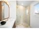 Bathroom featuring an enclosed glass shower, neutral tile, and modern fixtures at 265 S Monroe St, Denver, CO 80209