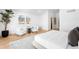 Bright and airy bedroom featuring hardwood floors and cozy seating area at 265 S Monroe St, Denver, CO 80209