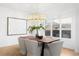 Elegant dining room with a modern chandelier and a large window with lots of light at 265 S Monroe St, Denver, CO 80209